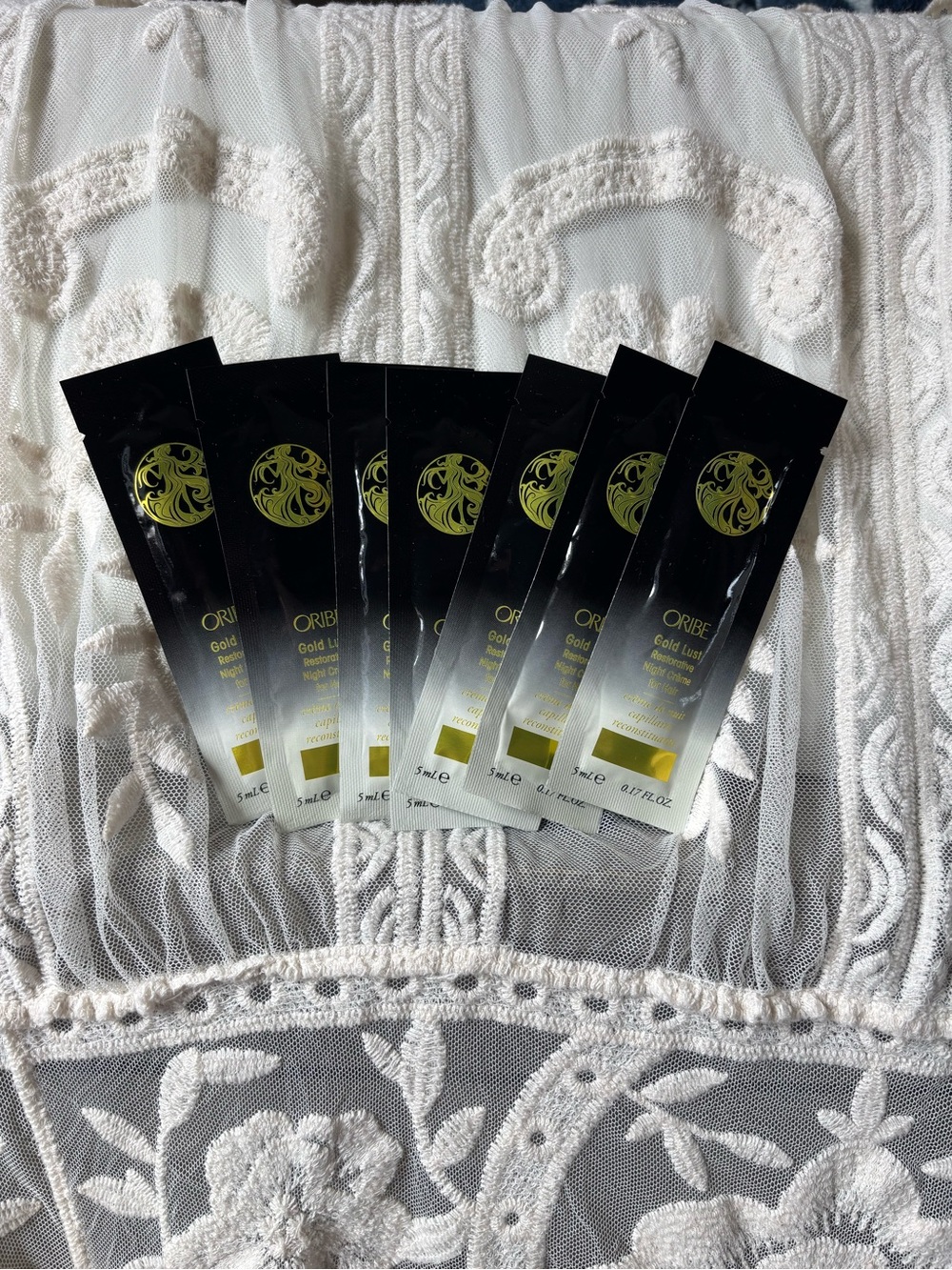 Oribe Gold Lust Sample Sachets in Black and Gold